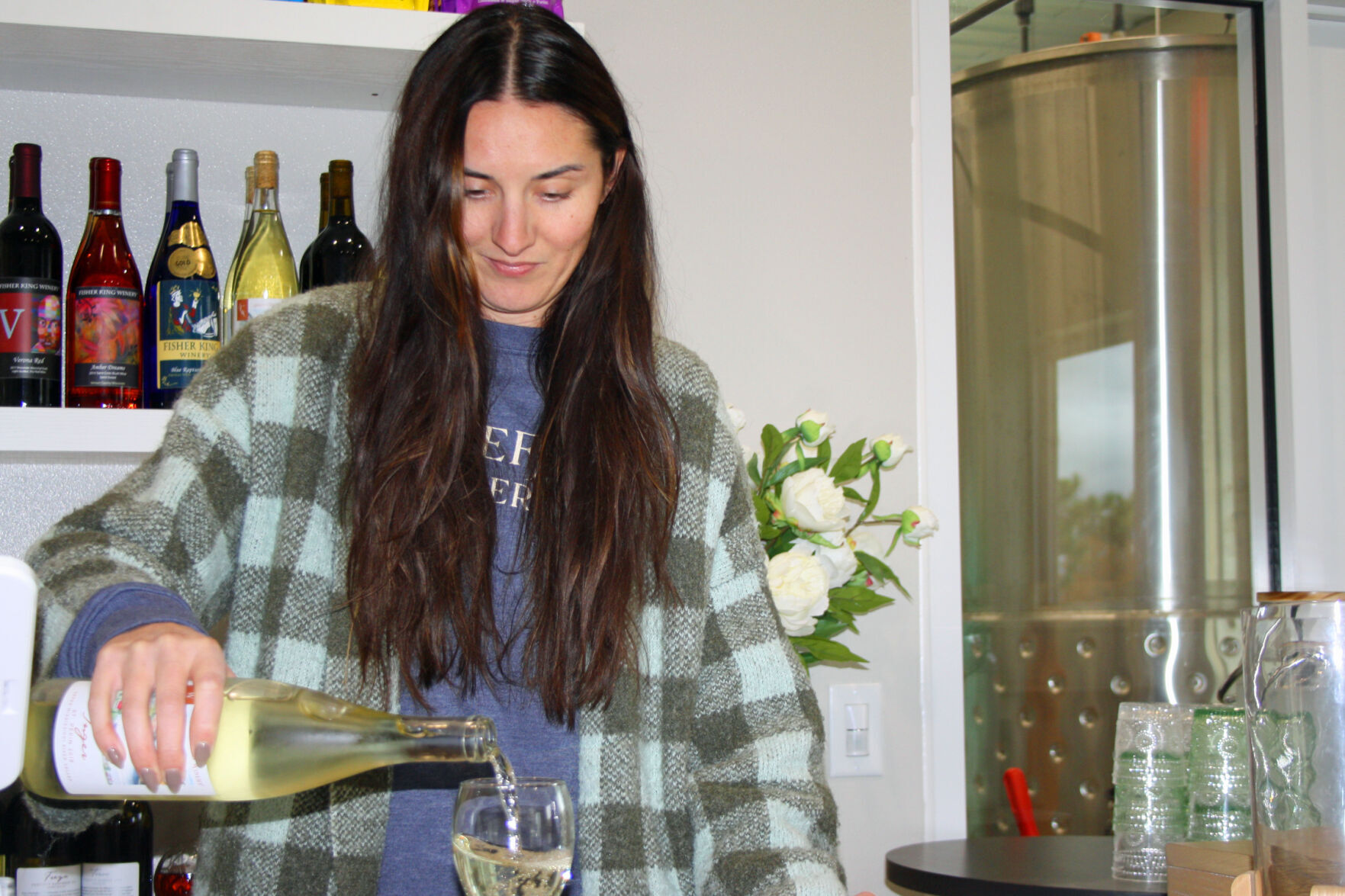 Kelsey pours white wine